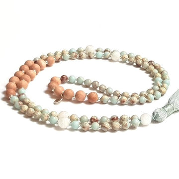 Handmade Focusing Mala Necklace – Rosewood, Moonstone & Jasper curled on the table